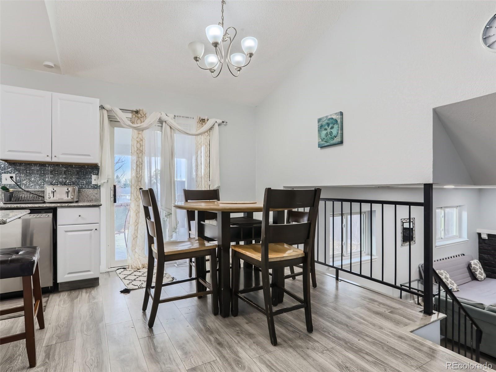 5941 South Perth Street Centennial, CO 80015 - Photo 8 of 28 a view of a dining room with furniture and wooden floor