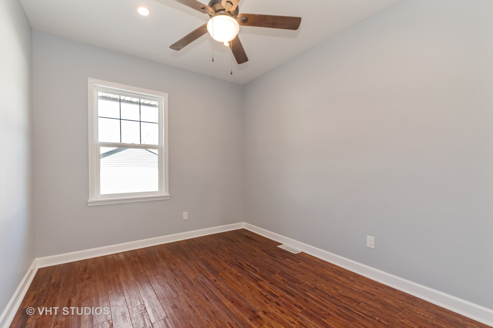 609 North Reed Street Joliet, IL 60435 - Photo 11 of 19 an empty room with a window and wooden floor