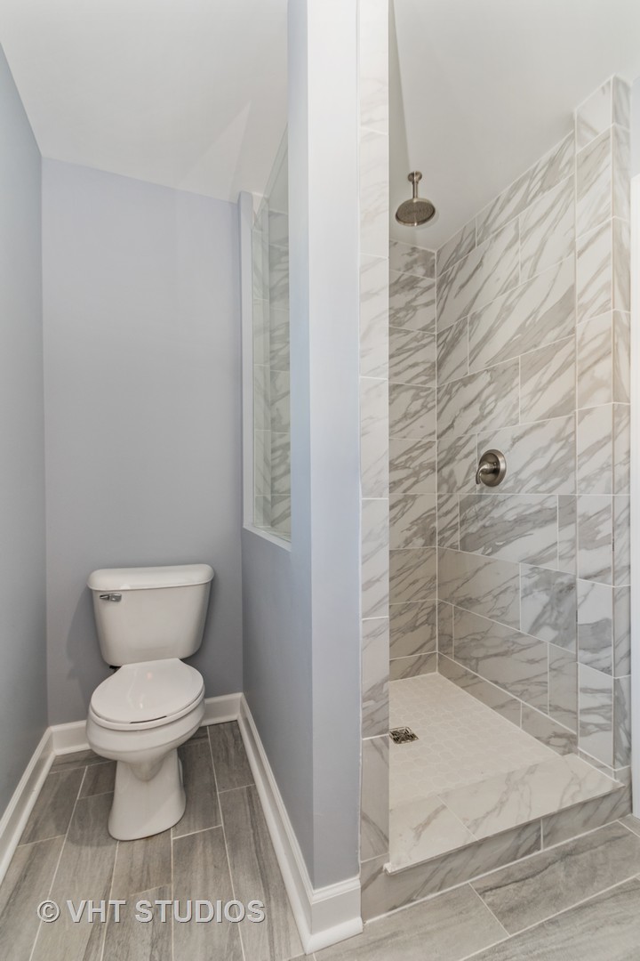 609 North Reed Street Joliet, IL 60435 - Photo 15 of 19 a bathroom with a toilet and a shower