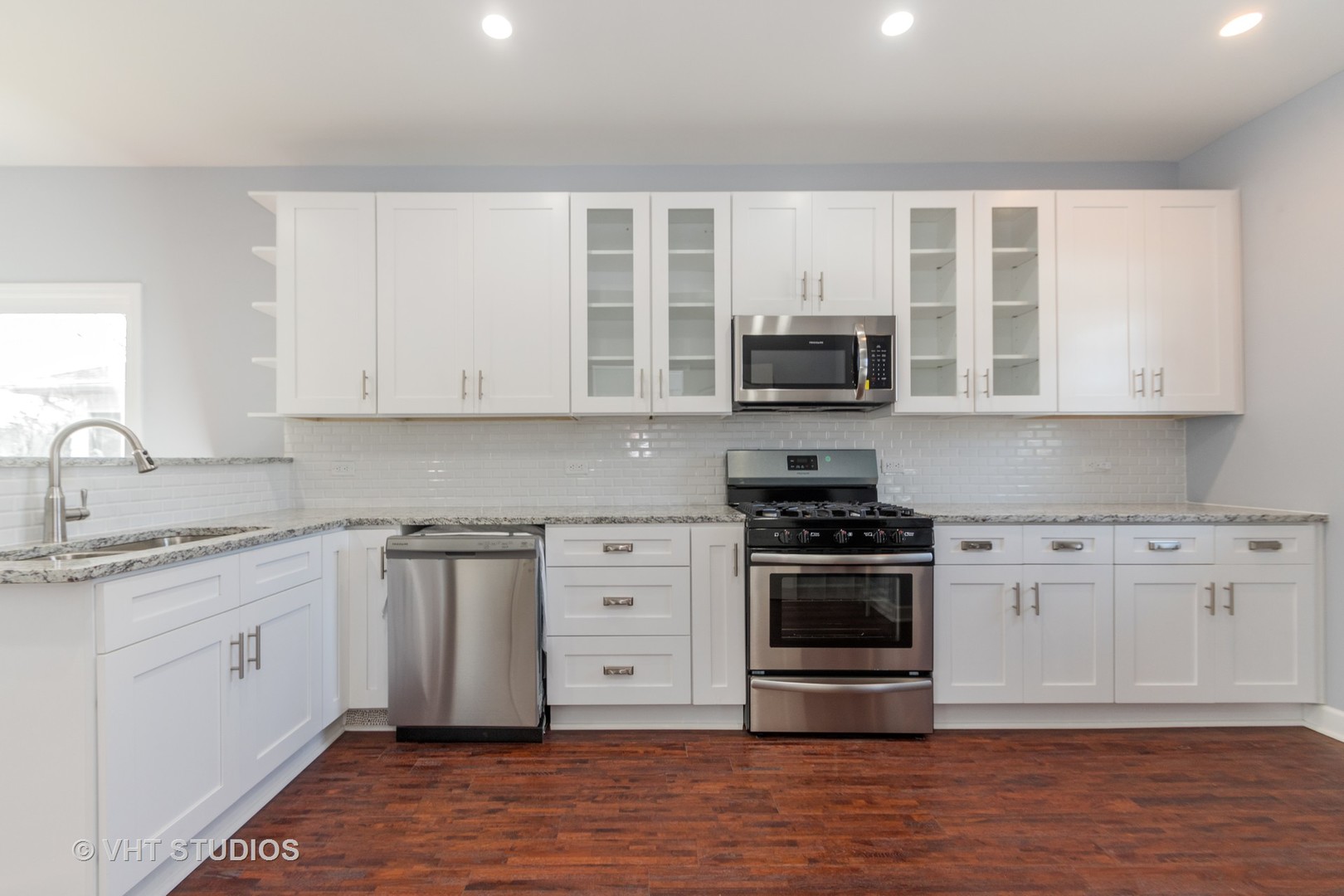 609 North Reed Street Joliet, IL 60435 - Photo 5 of 19 a kitchen with stainless steel appliances granite countertop a stove and a sink
