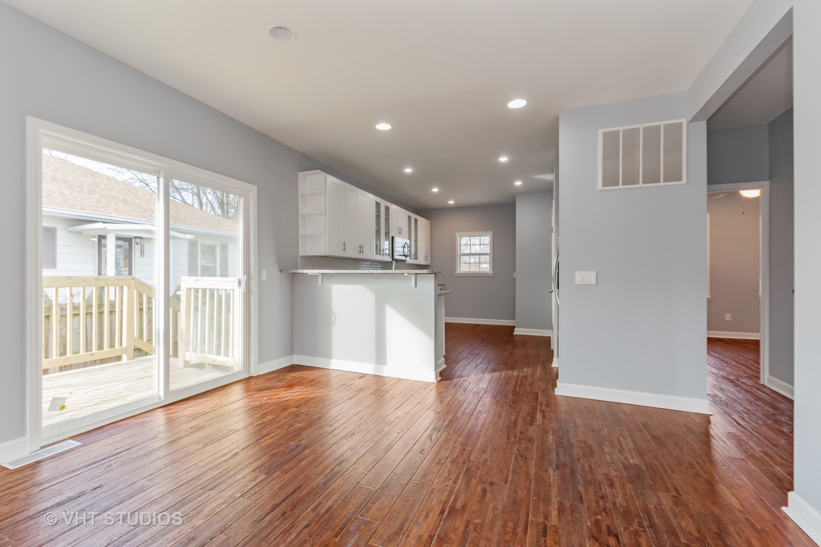 609 North Reed Street Joliet, IL 60435 - Photo 7 of 19 a view of empty room with wooden floor and kitchen