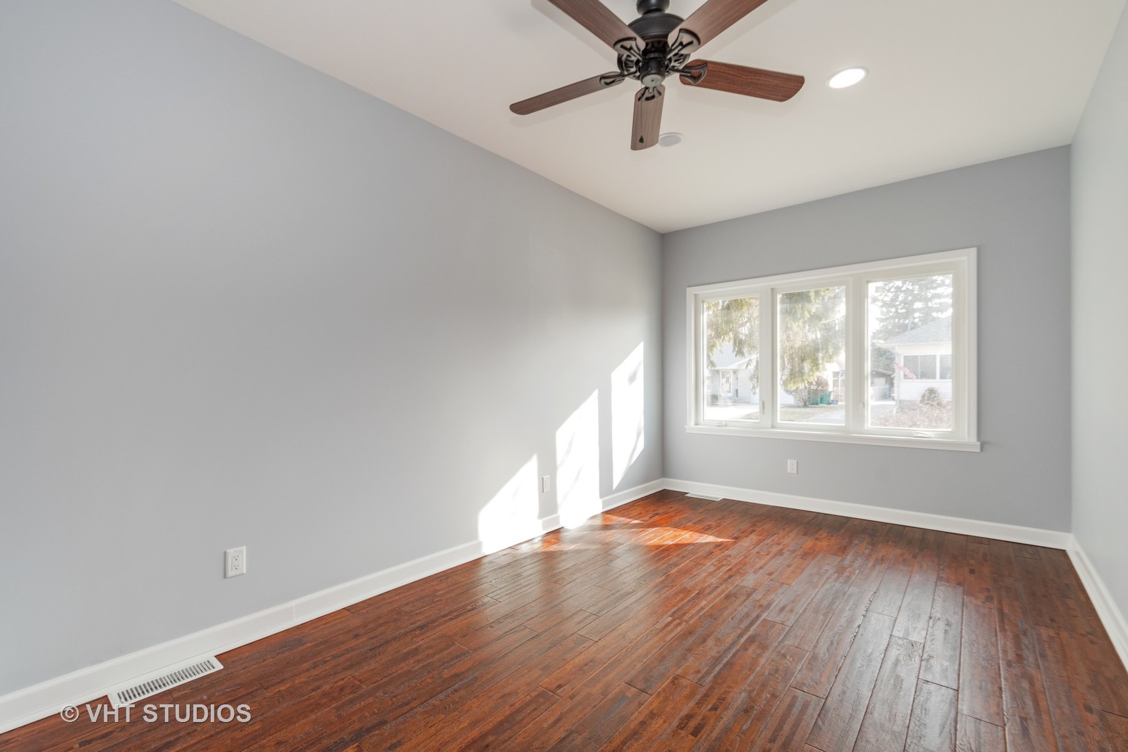 609 North Reed Street Joliet, IL 60435 - Photo 10 of 19 an empty room with wooden floor fan and windows