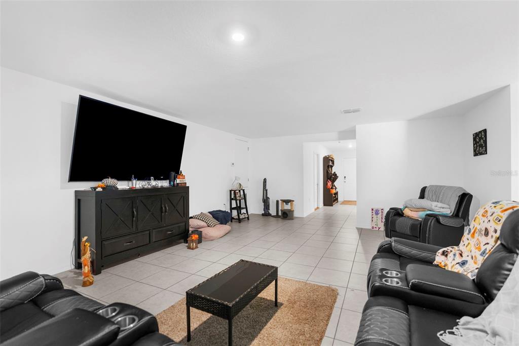 5637 East Tangelo Lane Inverness, FL 34453 - Photo 7 of 23 a living room with furniture and a flat screen tv