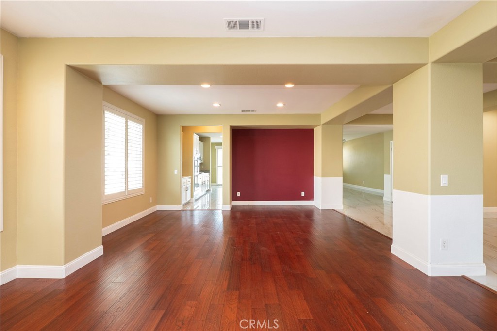 19128 Trail Ride Court Perris, CA 92570 - Photo 11 of 50 a view of an empty room with wooden floor and a window