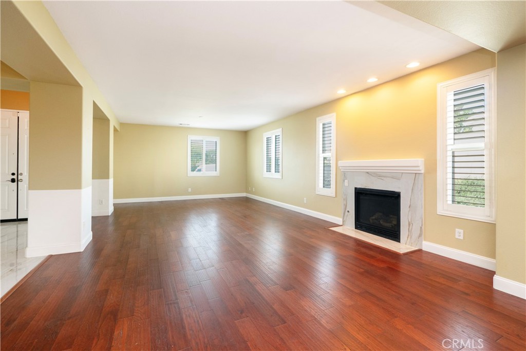 19128 Trail Ride Court Perris, CA 92570 - Photo 12 of 50 a view of an empty room with wooden floor and a window