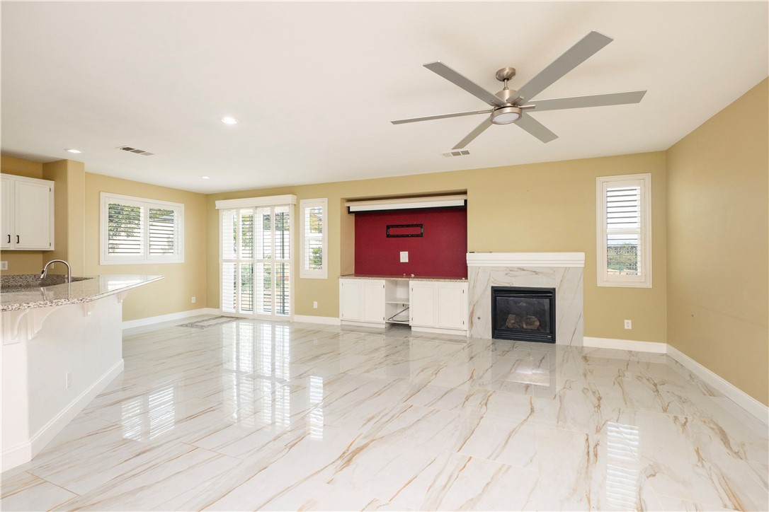 19128 Trail Ride Court Perris, CA 92570 - Photo 14 of 50 a view of an empty room with a fireplace and a window