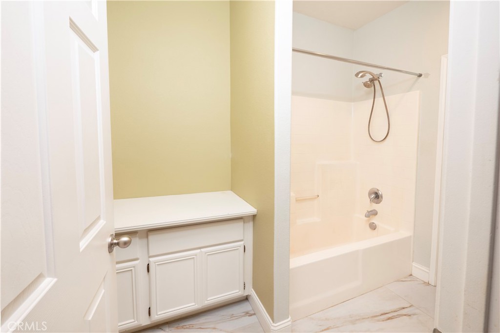 19128 Trail Ride Court Perris, CA 92570 - Photo 16 of 50 a bathroom with a shower