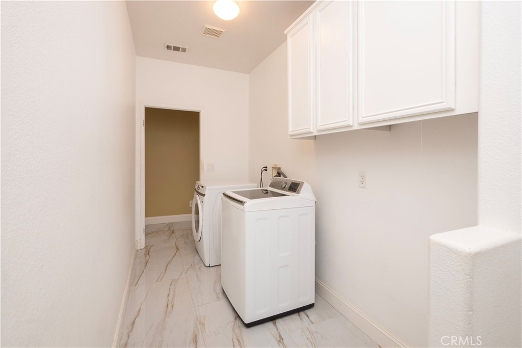 19128 Trail Ride Court Perris, CA 92570 - Photo 17 of 50 a utility room with dryer and washer