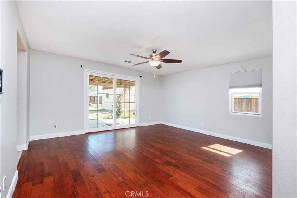 19128 Trail Ride Court Perris, CA 92570 - Photo 18 of 50 a view of an empty room with wooden floor and a window