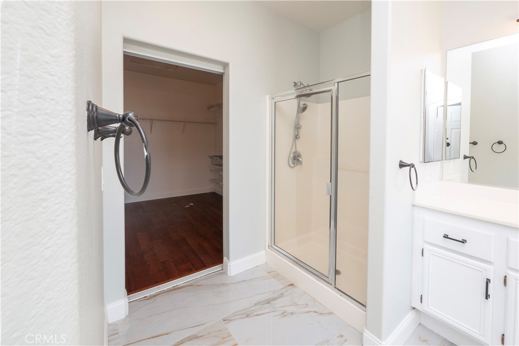 19128 Trail Ride Court Perris, CA 92570 - Photo 24 of 50 a bathroom with a shower and a mirror