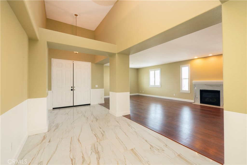 19128 Trail Ride Court Perris, CA 92570 - Photo 7 of 50 a view of an empty room with wooden floor and a window