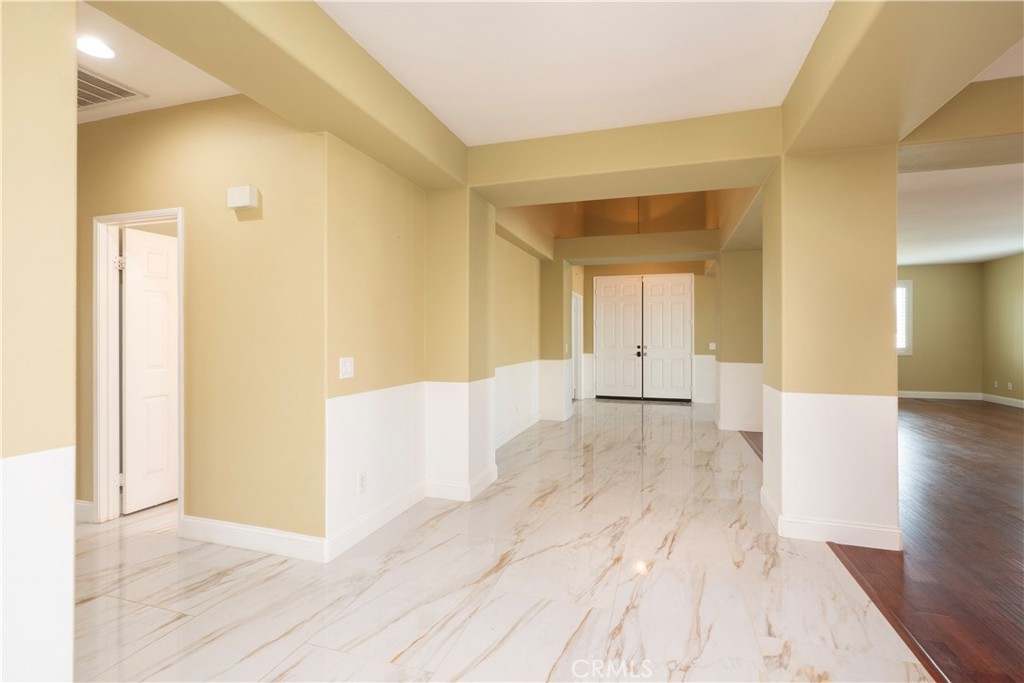 19128 Trail Ride Court Perris, CA 92570 - Photo 8 of 50 a view of a hallway with wooden floor