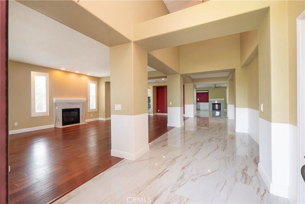 19128 Trail Ride Court Perris, CA 92570 - Photo 9 of 50 a view of a livingroom with wooden floor and a fireplace