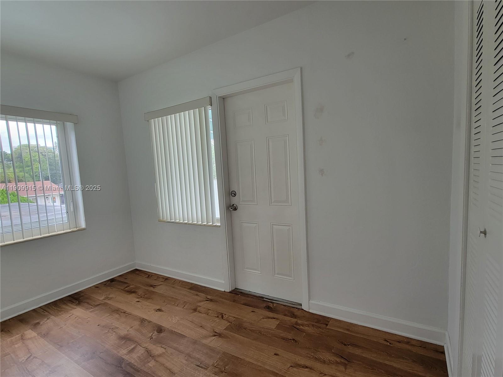 3433 Southwest 12th Street, Unit UPSTAIRS Miami, FL 33135 - Photo 18 of 23 Small bedroom view in with exit door to huge covered 2nd floor patio