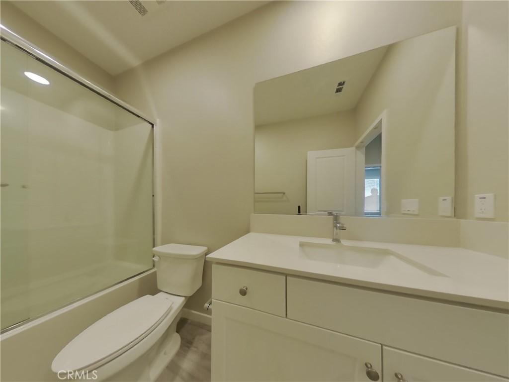36567 Pepino Court Wildomar, CA 92595 - Photo 14 of 31 a bathroom with a sink a toilet and a mirror