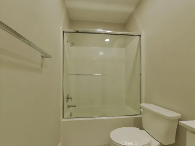 a bathroom with a toilet and shower