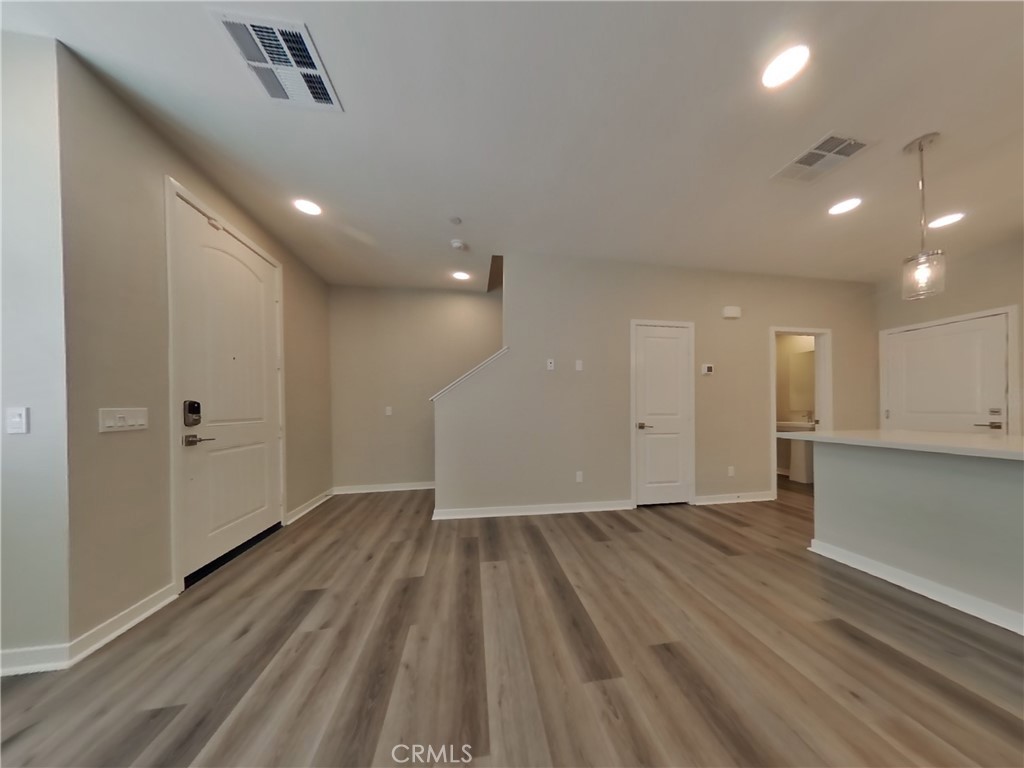 36567 Pepino Court Wildomar, CA 92595 - Photo 2 of 31 an empty room with wooden floor and windows