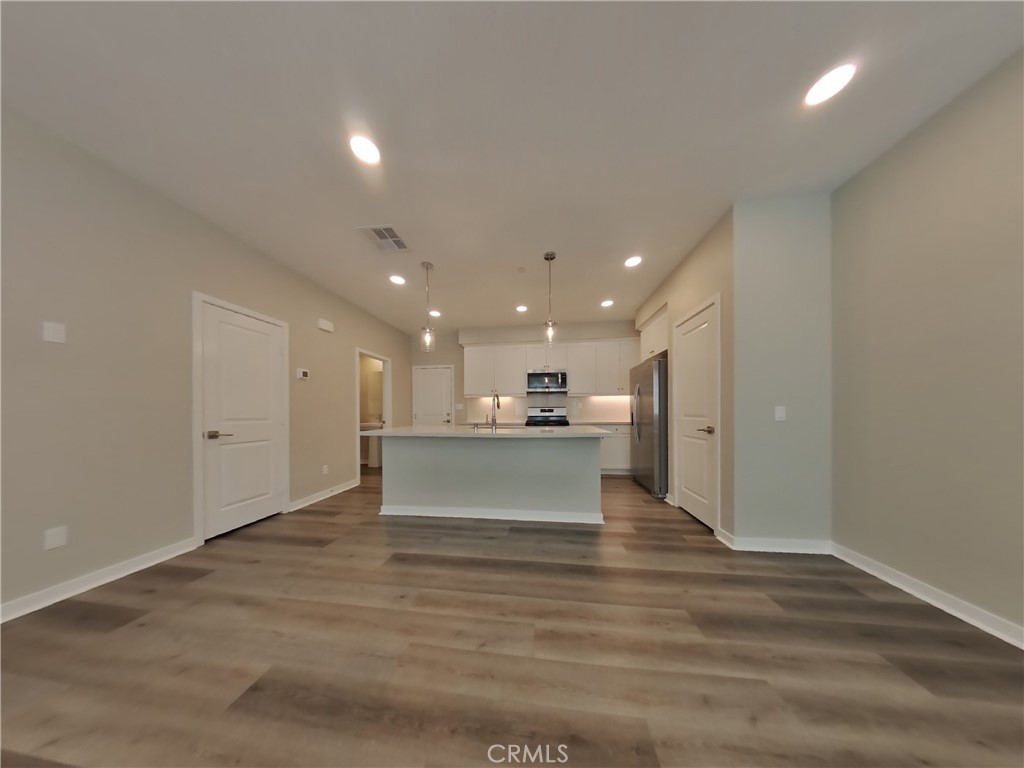 36567 Pepino Court Wildomar, CA 92595 - Photo 3 of 31 a view of kitchen and hall with wooden floor