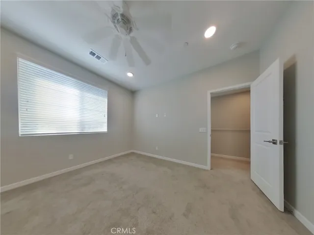 an empty room with windows and closet