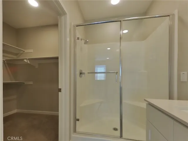 a bathroom with a glass shower door