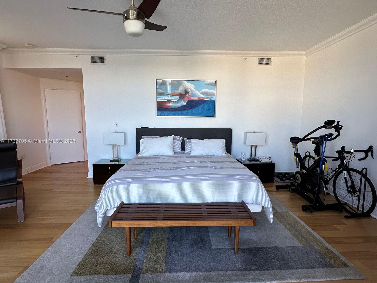 741 Crandon Boulevard, Unit PH4 Key Biscayne, FL 33149 - Photo 13 of 29 a bedroom with a bed and wooden floor