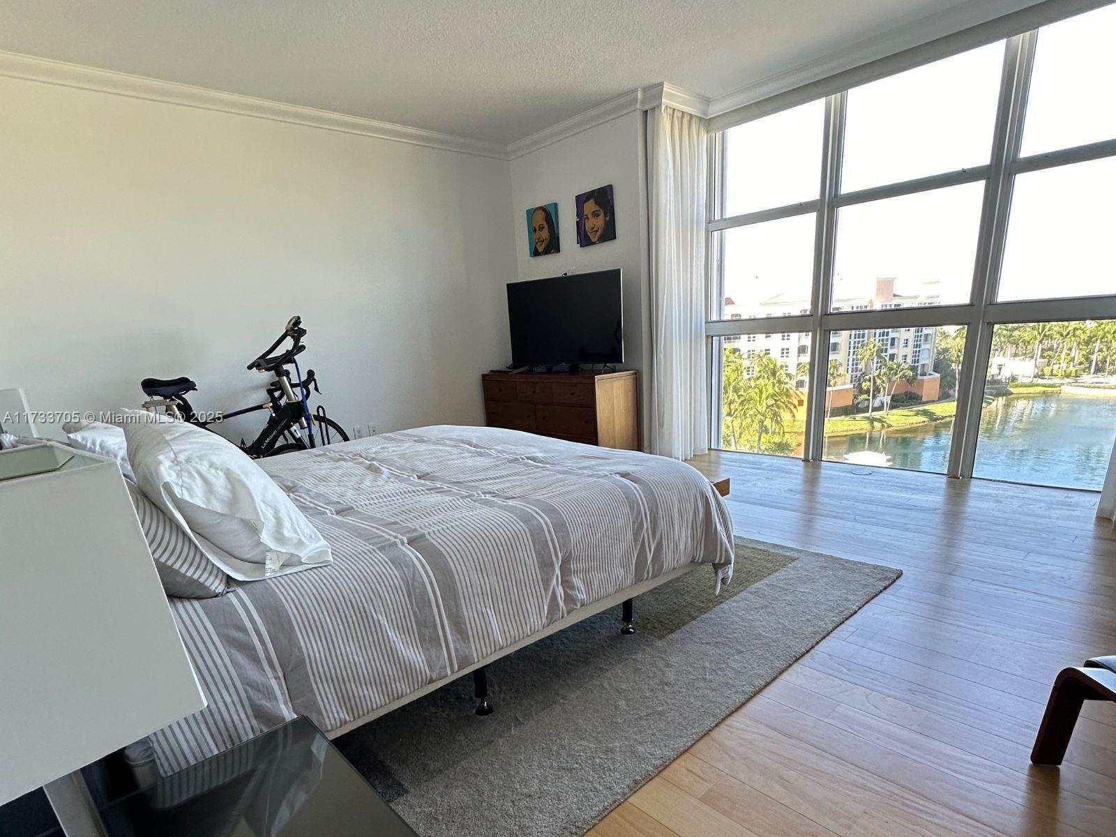 741 Crandon Boulevard, Unit PH4 Key Biscayne, FL 33149 - Photo 15 of 29 a bedroom with a bed and a large window