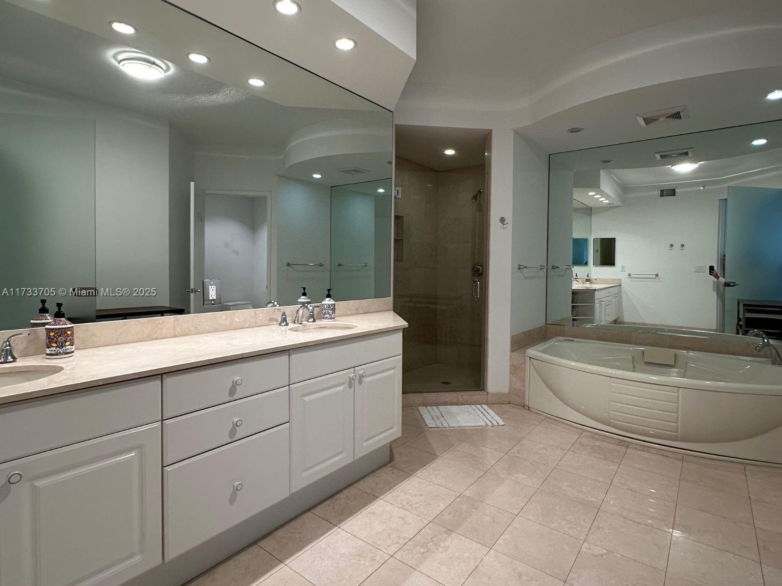 741 Crandon Boulevard, Unit PH4 Key Biscayne, FL 33149 - Photo 17 of 29 a spacious bathroom with a double vanity sink and a mirror