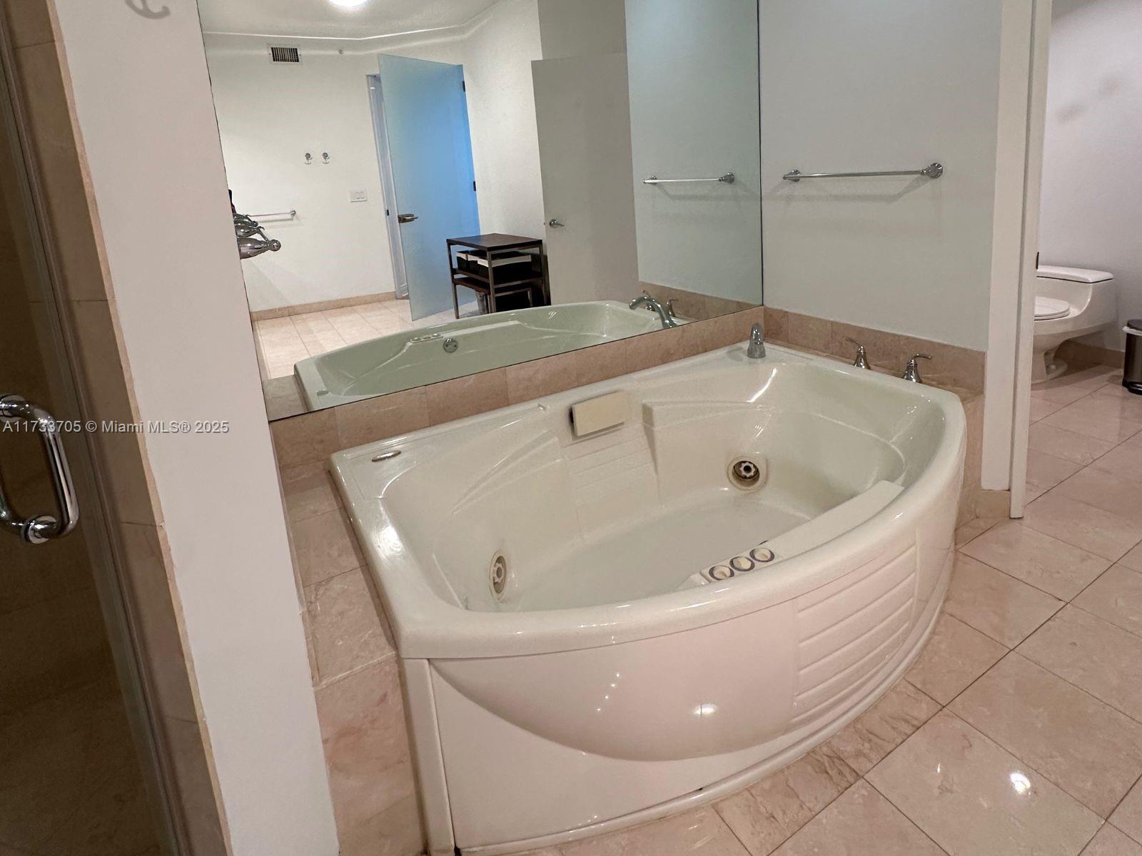 741 Crandon Boulevard, Unit PH4 Key Biscayne, FL 33149 - Photo 18 of 29 a bathroom with a tub and sink