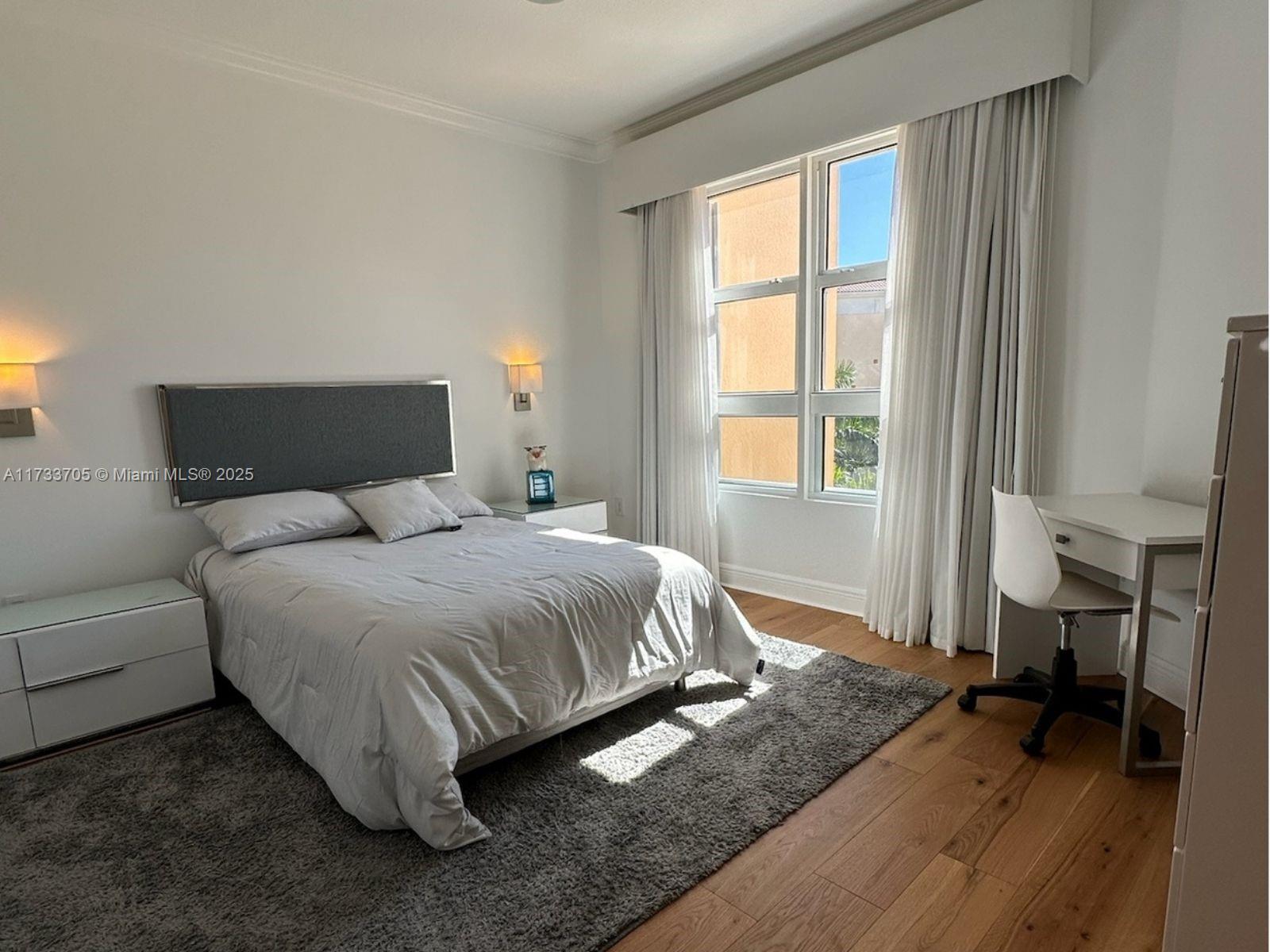 741 Crandon Boulevard, Unit PH4 Key Biscayne, FL 33149 - Photo 20 of 29 a bedroom with a bed and a window