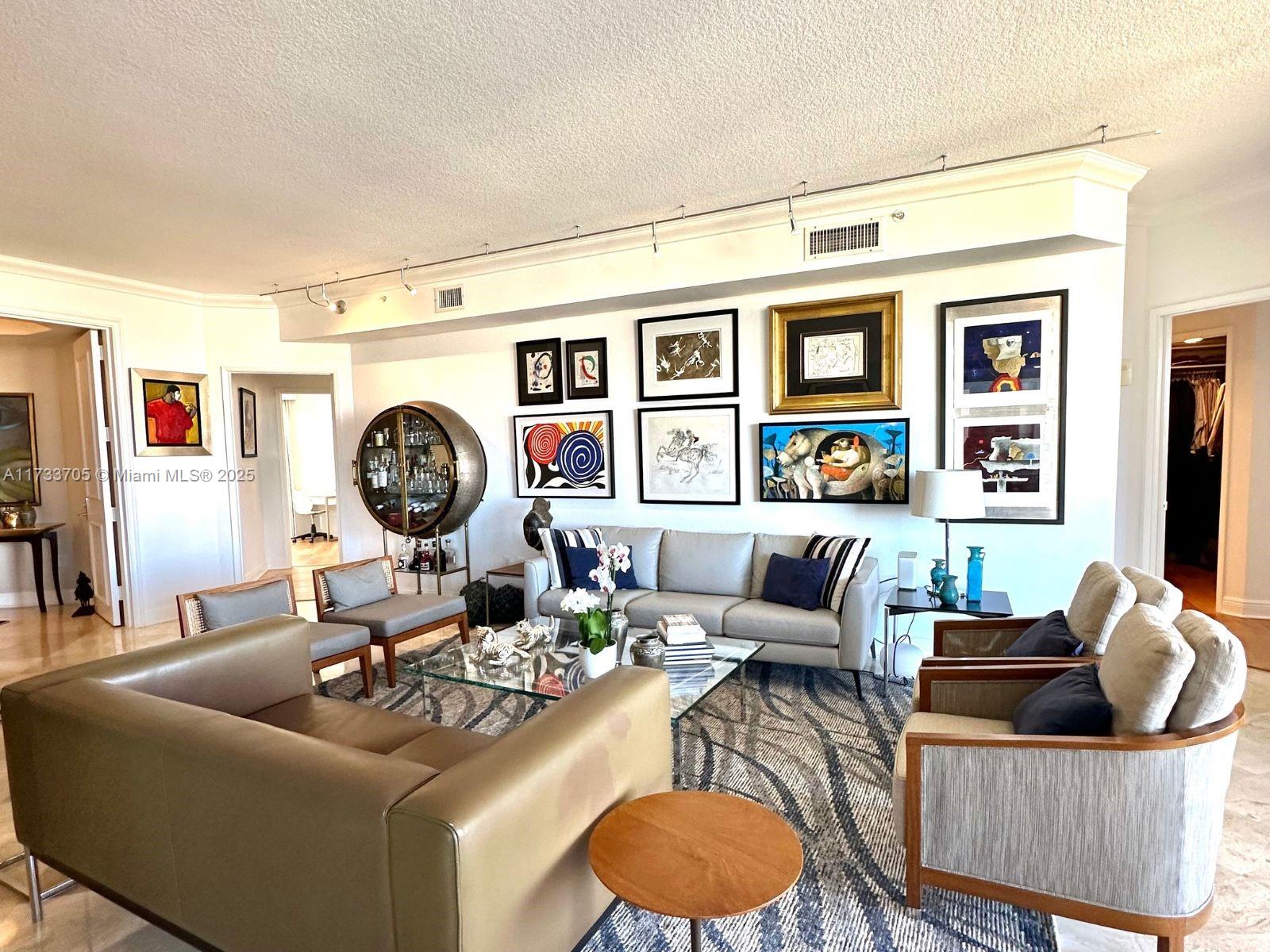 741 Crandon Boulevard, Unit PH4 Key Biscayne, FL 33149 - Photo 2 of 29 a living room with furniture a rug and a fireplace