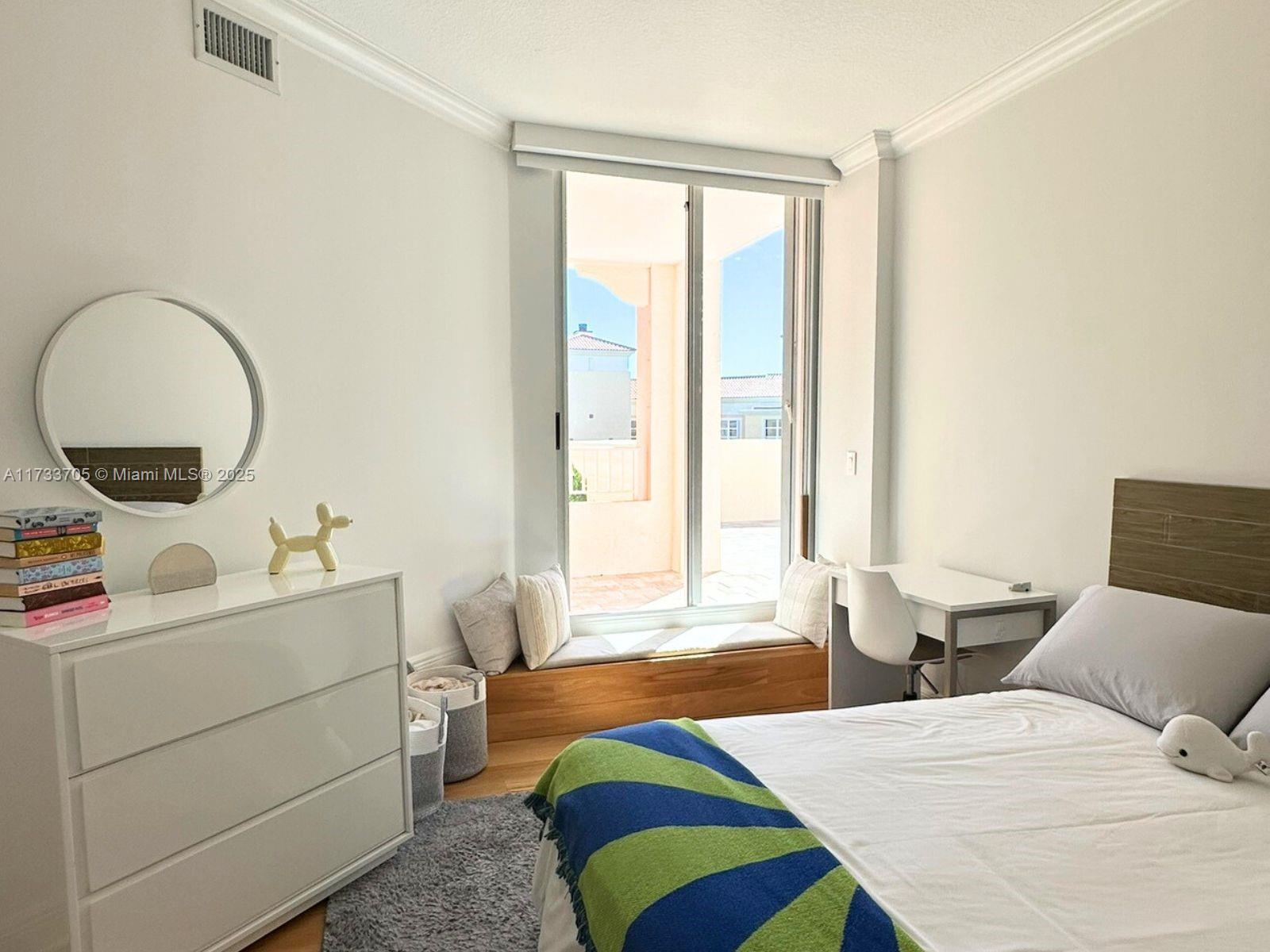 741 Crandon Boulevard, Unit PH4 Key Biscayne, FL 33149 - Photo 22 of 29 a bedroom with a bed and windows