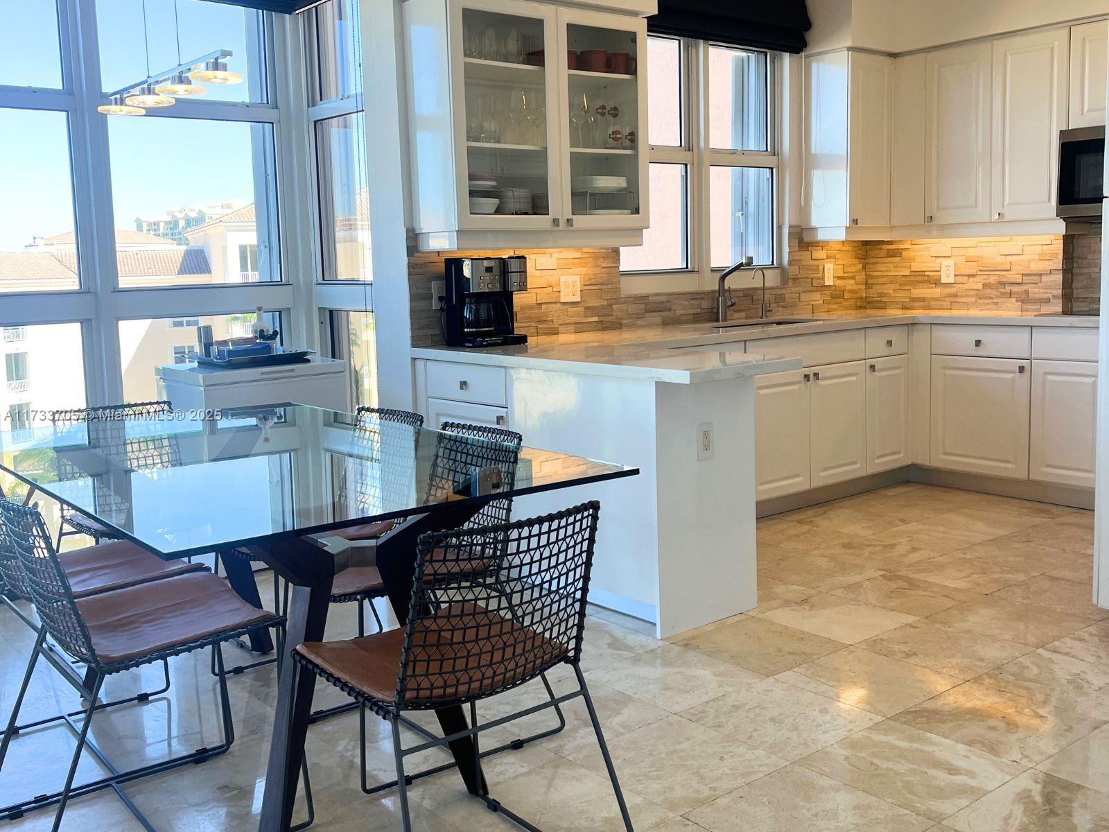 741 Crandon Boulevard, Unit PH4 Key Biscayne, FL 33149 - Photo 9 of 29 a kitchen with a stove a sink and cabinets