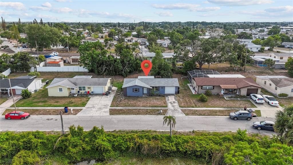 1623 Plum Tree Road Holiday, FL 34690 - Photo 29 of 33 an aerial view of a house with a yard and lake view