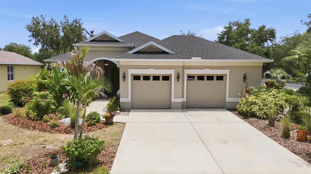 428 Snapdragon Loop Bradenton, FL 34212 - Photo 3 of 33 a front view of a house with a garden
