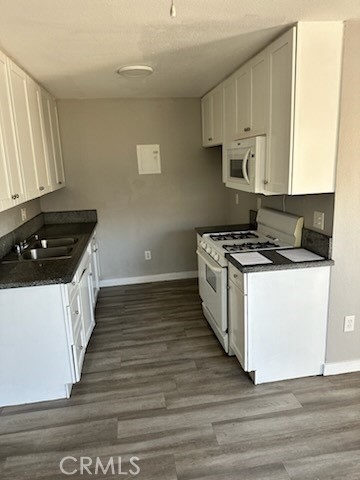 11906 Hart Street, Unit 6 North Hollywood, CA 91605 - Photo 8 of 10 a kitchen with wooden floor and a stove