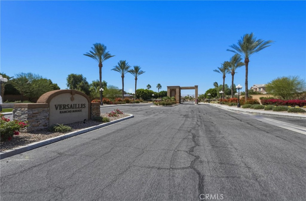 9 Orleans Road Rancho Mirage, CA 92270 - Photo 7 of 71 a front view of a house with a yard and palm trees