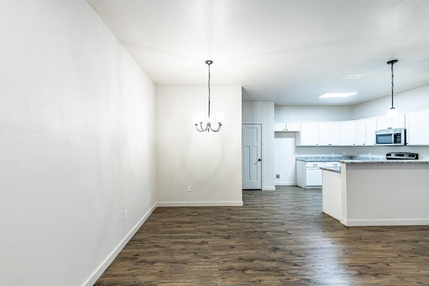 5517 121st Street, Unit B Lubbock, TX 79424 - Photo 13 of 37 a view of a kitchen with granite countertop cabinets and a sink