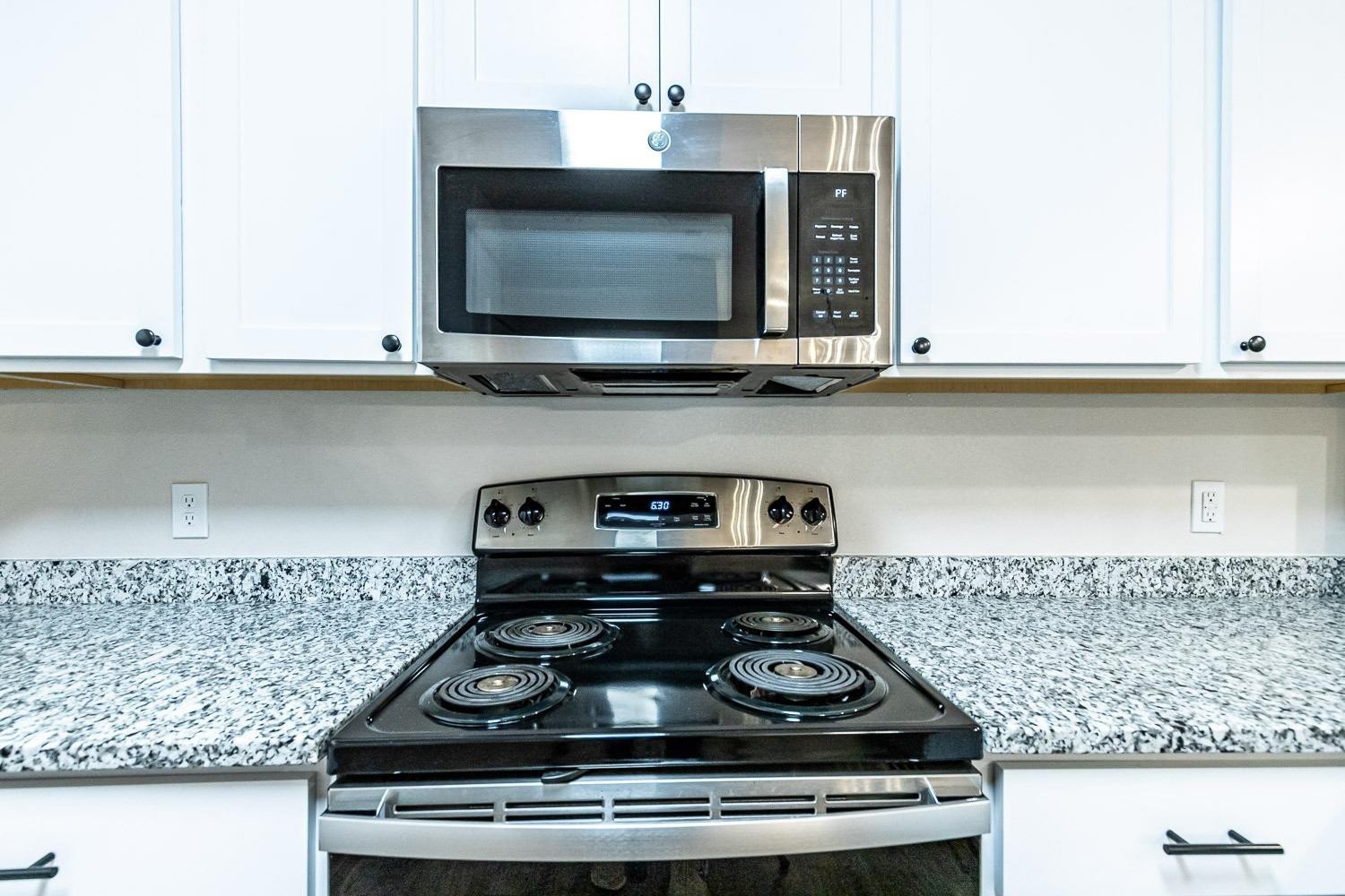 5517 121st Street, Unit B Lubbock, TX 79424 - Photo 18 of 37 a kitchen with a stove and a microwave