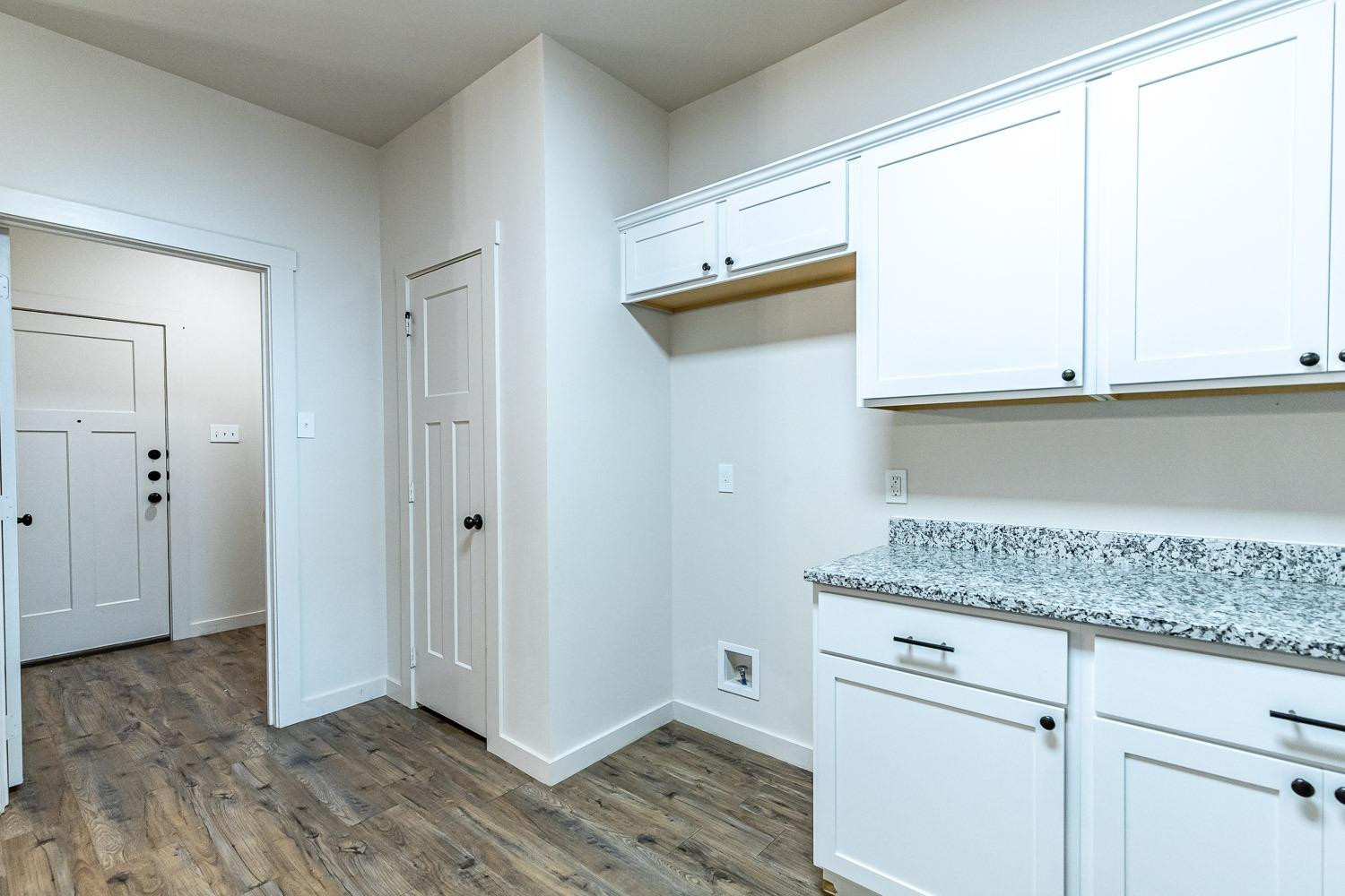 5517 121st Street, Unit B Lubbock, TX 79424 - Photo 21 of 37 a kitchen with granite countertop white cabinets and a window
