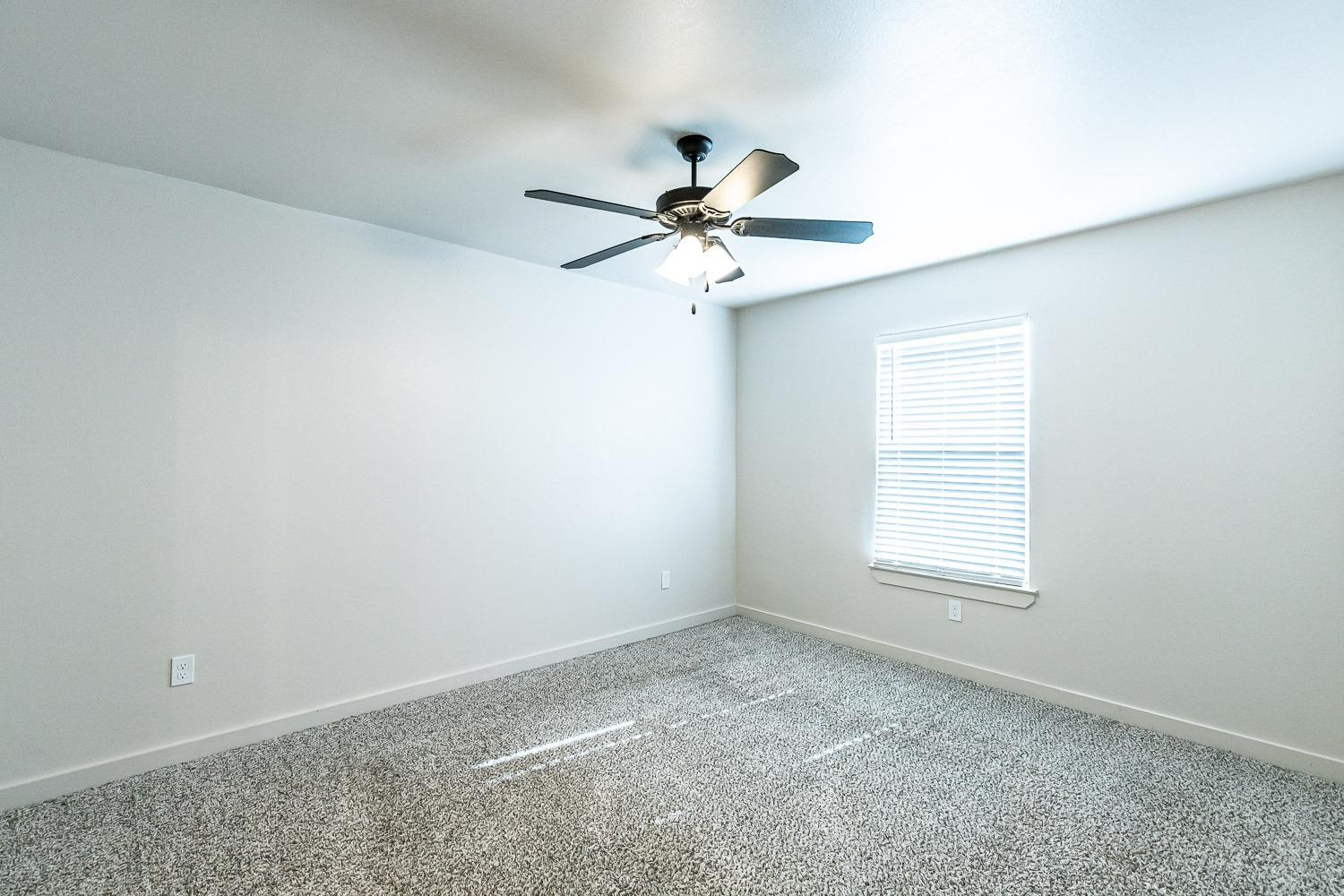 5517 121st Street, Unit B Lubbock, TX 79424 - Photo 24 of 37 an empty room with a window and a fan