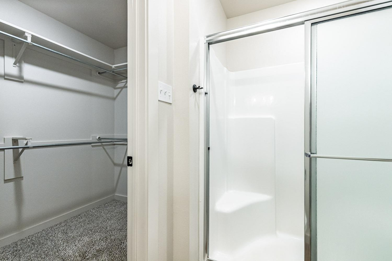 5517 121st Street, Unit B Lubbock, TX 79424 - Photo 28 of 37 a bathroom with a glass shower door