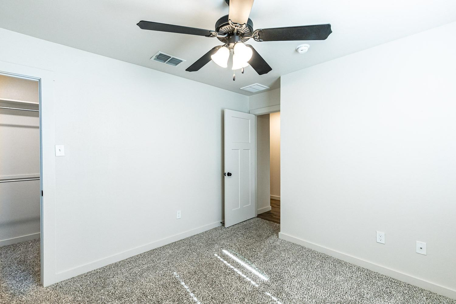 5517 121st Street, Unit B Lubbock, TX 79424 - Photo 31 of 37 a view of a livingroom with a ceiling fan and kitchen space