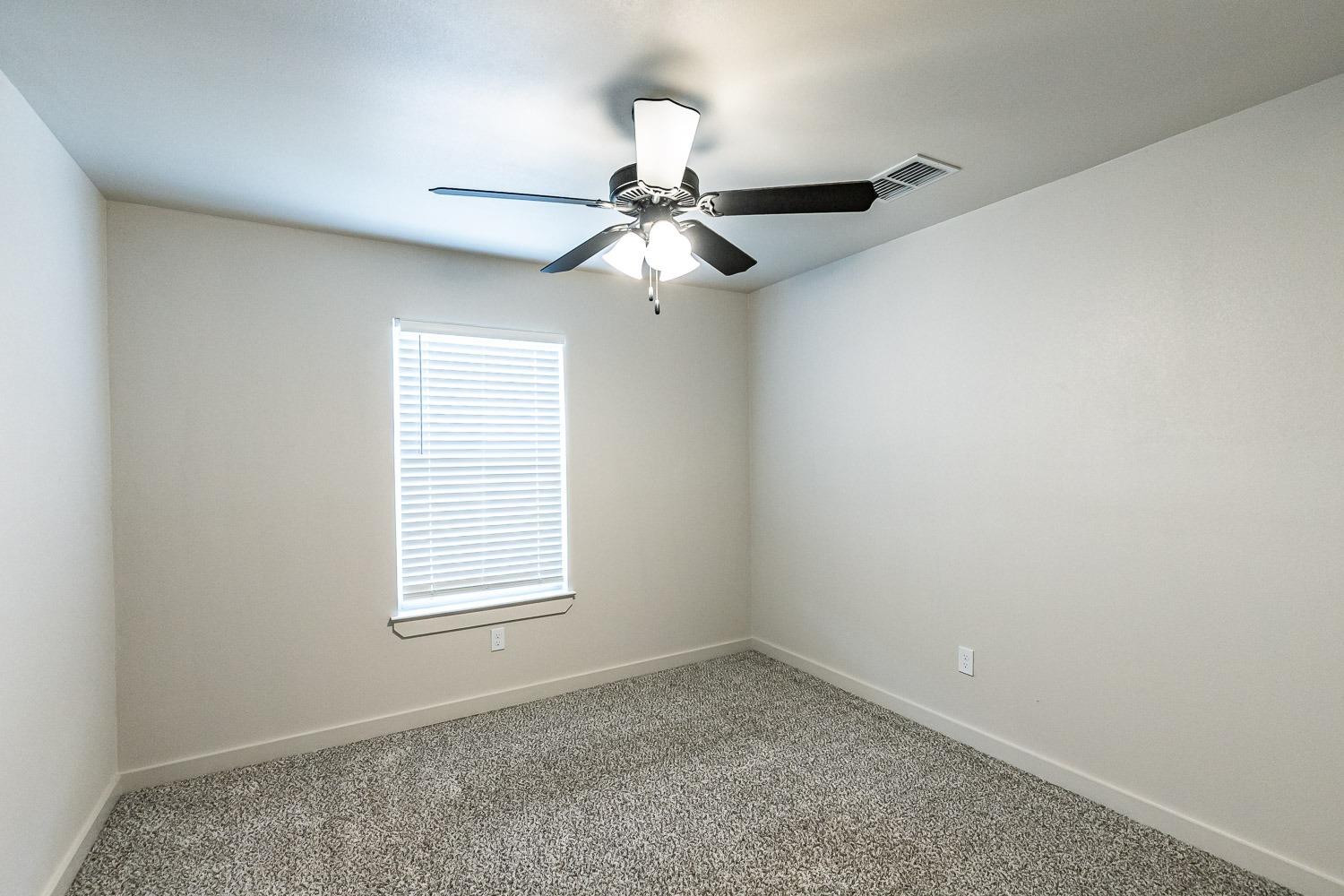 5517 121st Street, Unit B Lubbock, TX 79424 - Photo 37 of 37 an empty room with a window and a fan