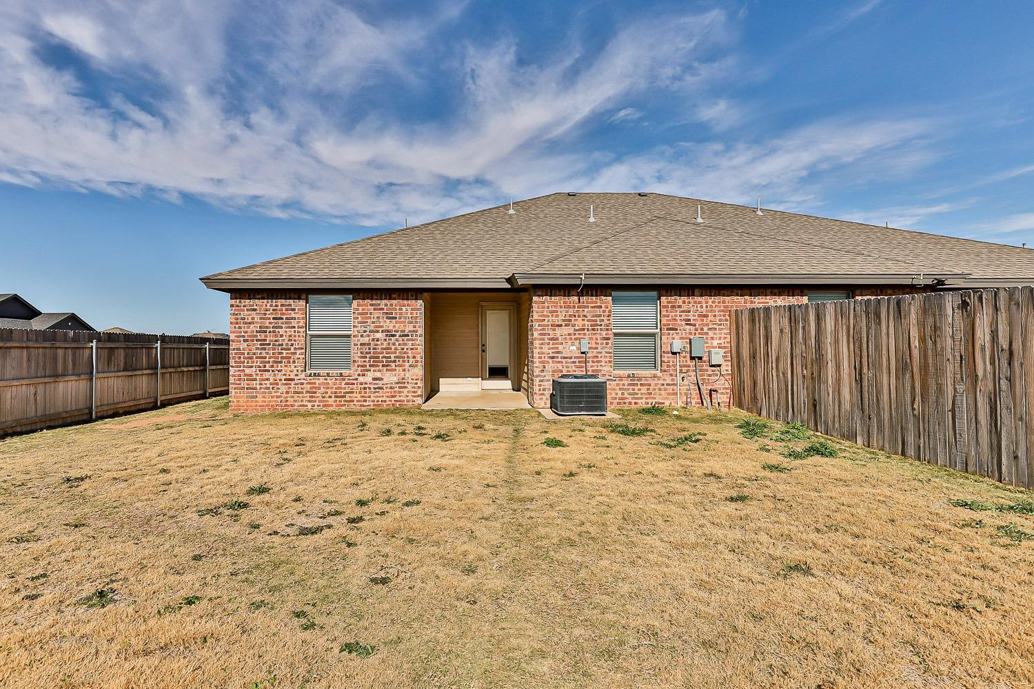5517 121st Street, Unit B Lubbock, TX 79424 - Photo 5 of 37 a front view of a house with a yard