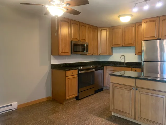a kitchen with cabinets a sink and appliances