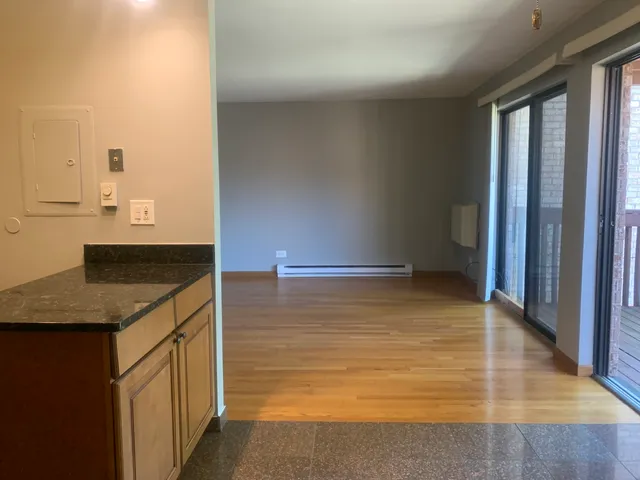 a kitchen with kitchen island a sink a counter top space and cabinets