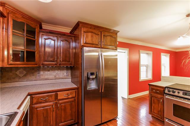 1400 Gratton Road Clarksville, TN 37043 - Photo 3 of 20 Kitchen with real wooden cabinets, tile back splash, and stainless steel appliances