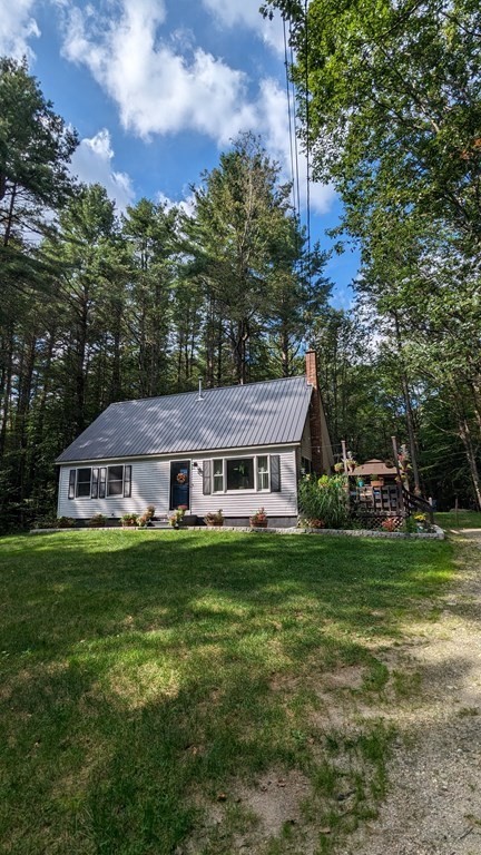 48 Old Cyrus Stage Road Rowe, MA 01367 - Photo 1 of 37 a aerial view of a house with a yard table and chairs