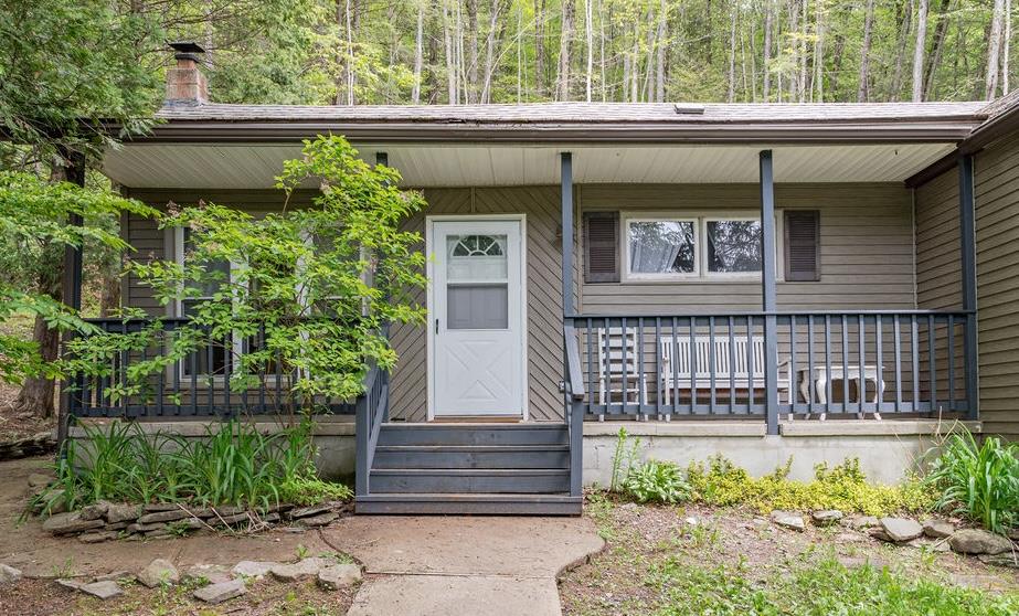 a front view of a house with plants
