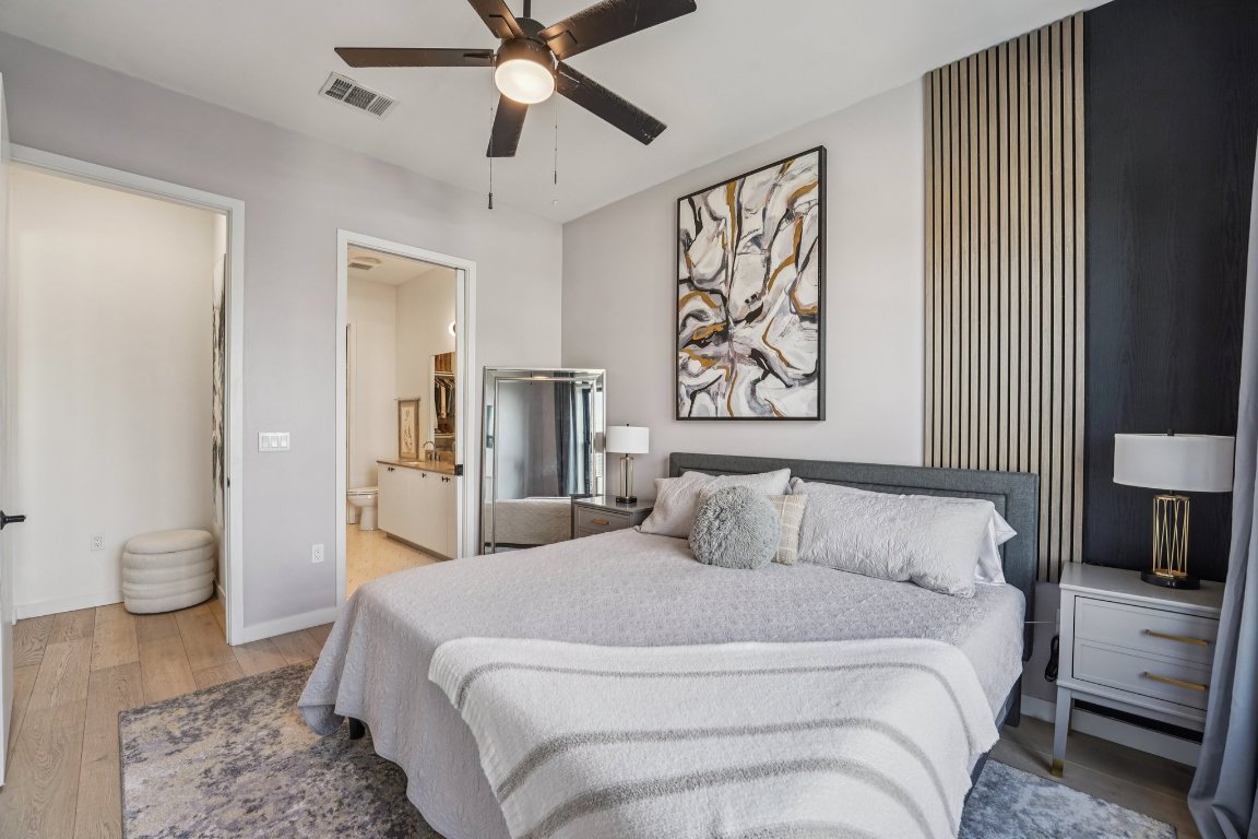 800 Embassy Drive, Unit 429 Austin, TX 78702 - Photo 15 of 40 a bedroom with a large bed and a chandelier